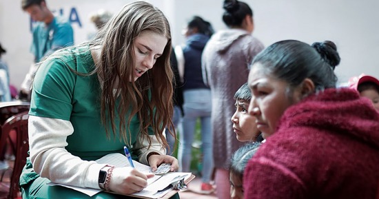 UNK student Kennady Schmidt works with a family during a medical outreach trip to Peru. Current and former Lopers assisted at six mobile medical clinics during their two-week stay. (Courtesy photo)